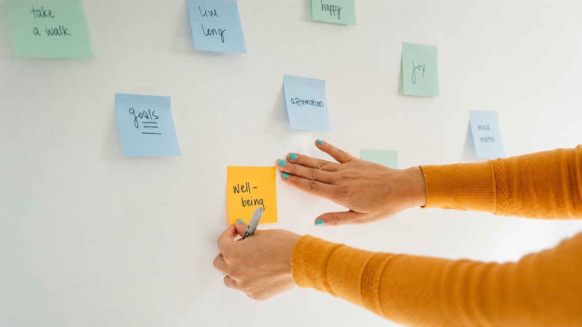 Sticky notes covering a wall, representing the quiet, repeated habit of self-editing before speaking