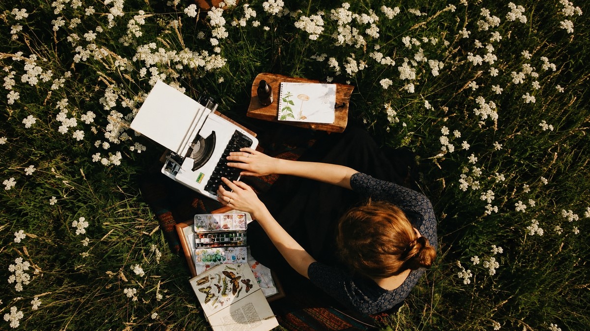 Vintage record player beside flowers, representing quiet effort and presence that often goes unnoticed