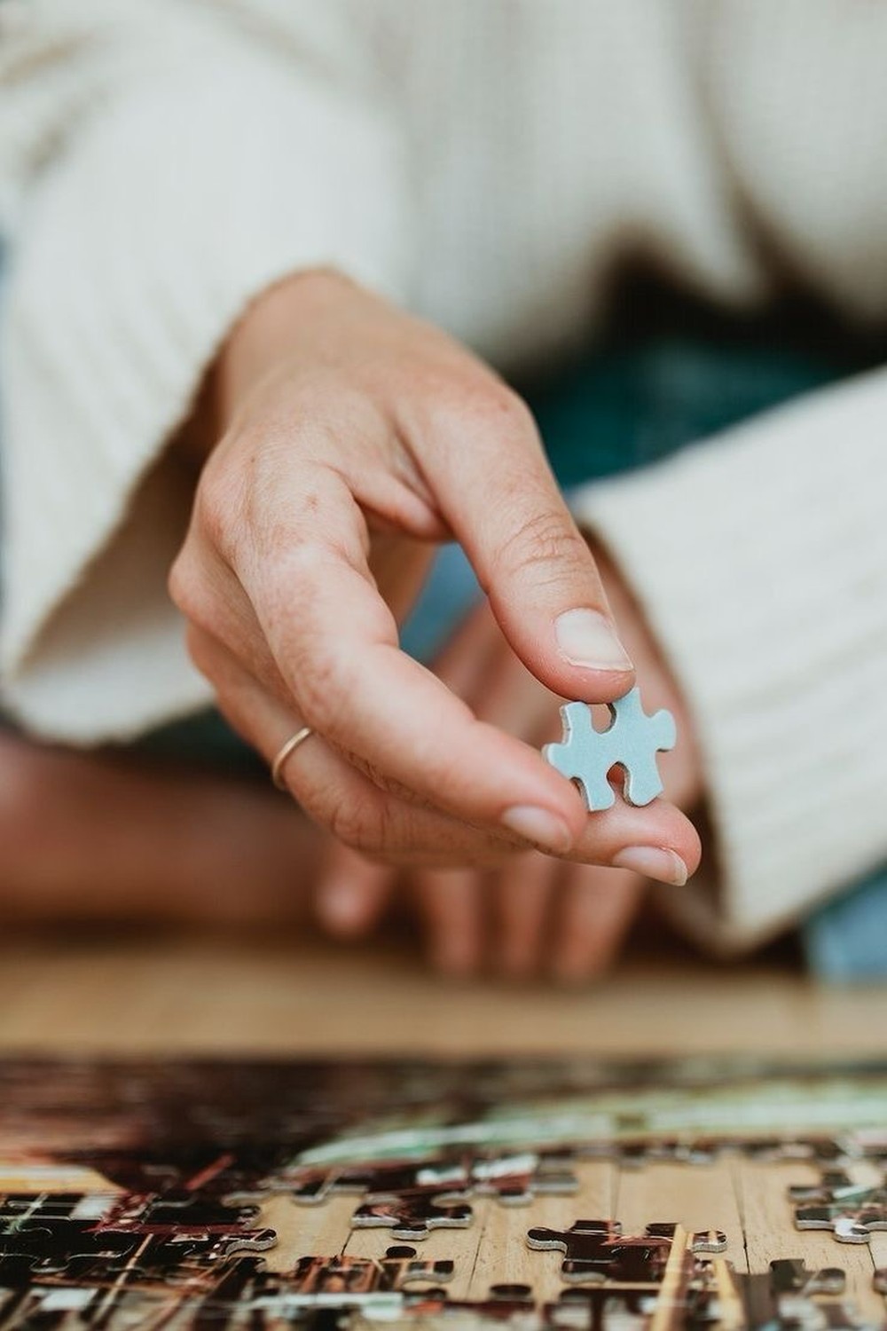 Hands holding a puzzle piece, representing an identity still in progress