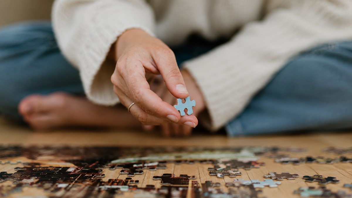 Hands holding a puzzle piece, representing an identity that is still in progress